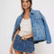model wearing light blue cropped denim jacket with front patch pockets