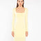up close of model wearing yellow square neck long sleeve knit maxi dress