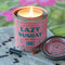 pink lazy sunday candle near a word search
