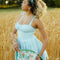 model wearing cream square bandana with dark teal green, blue, cream, red flowers
