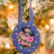 blue with pale pink posey round fabric frame ornament hanging from a tree