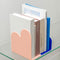 pink and blue acrylic scalloped bookends with books on a shelf