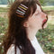 model wearing set of 6 various colorful printed slide barrettes