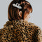 model wearing two white swans kissing hair barrette