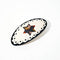round pony barrette with tortoise quilt inspired six point star and black trim