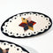 up close of round pony barrette with tortoise quilt inspired six point star and black trim