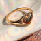 side view of gold ring with heart shaped locket