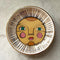 white trinket tray with sun face print and gold detail