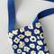 up close of royal blue wine tote with abstract cream floral print