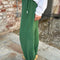 side view of model wearing cotton moss green balloon pants with side pockets