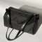 black nylon barrel handbag with leather buckle shoulder strap and trim