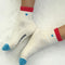 model wearing white crew socks with red trim and light blue embroidered heart