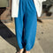 model wearing french terry teal blue balloon pants with side pockets