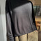 side view of model wearing black linen blend long sleeve top