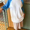 model wearing relaxed fit raglan tee with light blue sleeves
