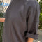 side view of model wearing dark slate oversized tee with extended sleeves