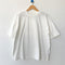 white oversized tee with oversized sleeves on a hanger