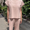 model wearing baby pink relaxed fit cotton tee with muscle type sleeves and side vents
