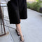 model wearing black cotton relaxed fit bermuda shorts