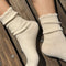 side view of model wearing white ribbed scalloped socks
