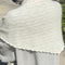 back view of model wearing naturel pointelle square shawl with scalloped edges