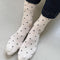 model wearing oatmeal socks with dainty all-over black dots