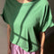 up close of model wearing avocado green relaxed fit tee