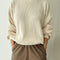 model wearing cream colored waffle sweatshirt with slight balloon sleeves