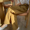 model wearing dijon yellow cotton straight leg work pants
