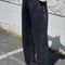 model wearing washed black arc pants with elastic waist, pockets, and barrel legs