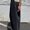 side view of model wearing washed black arc pants with elastic waist, pockets, and barrel legs