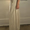 side view of model wearing naturel wide leg pants with side inlets