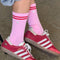 model wearing pink high crew socks with two red stripe top and silver embroidered heart