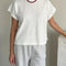 model wearing white relaxed tee with muscle tee sleeves and side vents at the hem