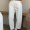 model wearing white relaxed fit pull on pants with side pockets