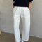 model wearing white relaxed fit pull on pants with side pockets