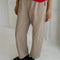 side view of model wearing khaki arc pants with side pockets and side leg panels