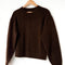 dark brown mohair pull over sweater on a hanger