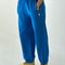 model wearing lagoon blue french terry balloon pants with side pockets and side panels