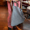 navy and white gingham rectangular bag on a chair