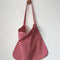 red and white gingham rectangular bag hanging on a hook