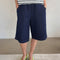 model wearing dark blue bermuda shorts with side pockets