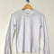white pointelle long sleeve tee on a hanger