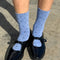 model wearing blue socks with navy polka dots