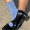 model wearing blue socks with navy polka dots