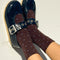 model wearing brown socks with blue polka dots