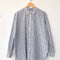 white relaxed fit button front shirt with side vents, collar and denim blue stripes on a hanger