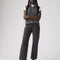 model wearing washed black relaxed fit straight leg jeans and grey sweater vest