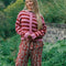 model wearing textured cardigan with red and pink horizontal stripes