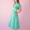 side view of model wearing green puff sleeve v-neck midi dress with  pale yellow ruffle under the bust